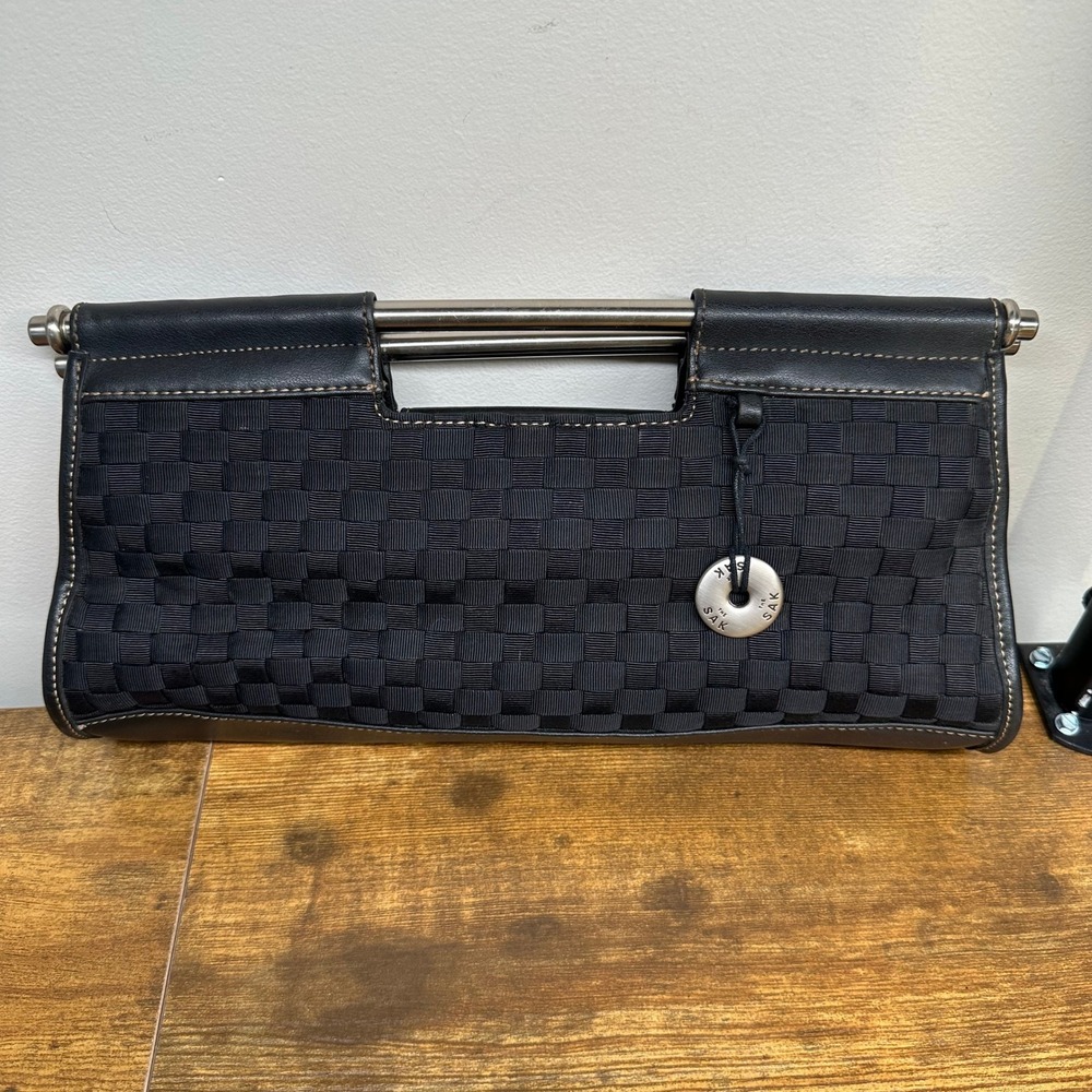 The Sak Black Woven Ribbon Leather Trim Clutch Bag Metal Bar Handle Red Lining